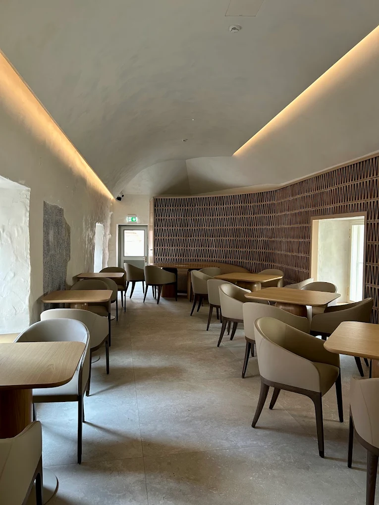 Tête-à-tête café dining room with sculptural chairs and oak tables